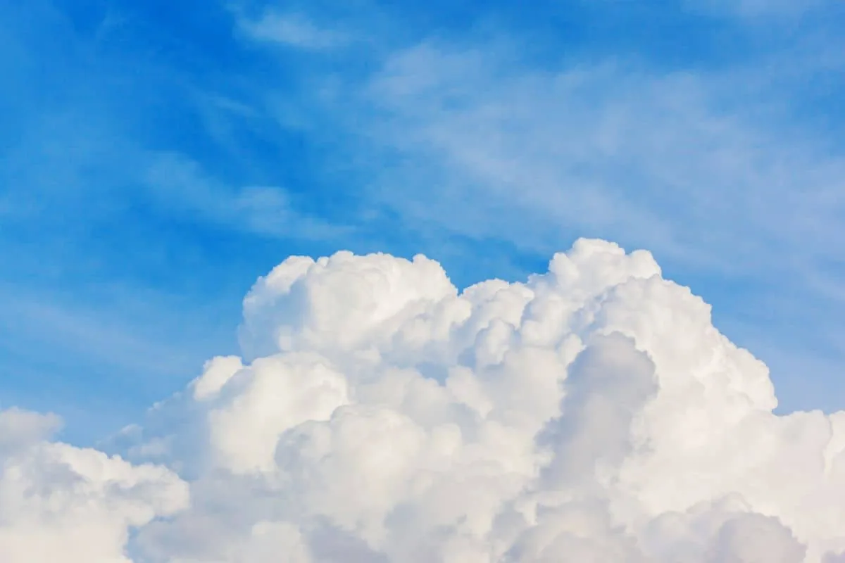 White cumulus clouds against a blue sky